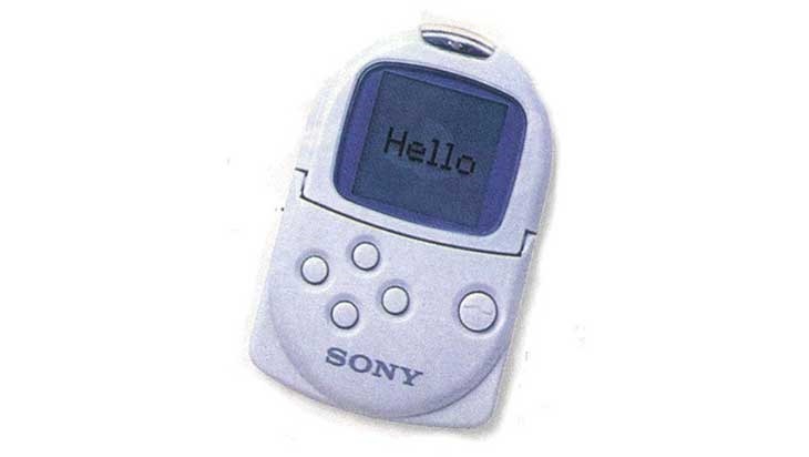 An old photo of a PocketStation with the intro “Hello” screen